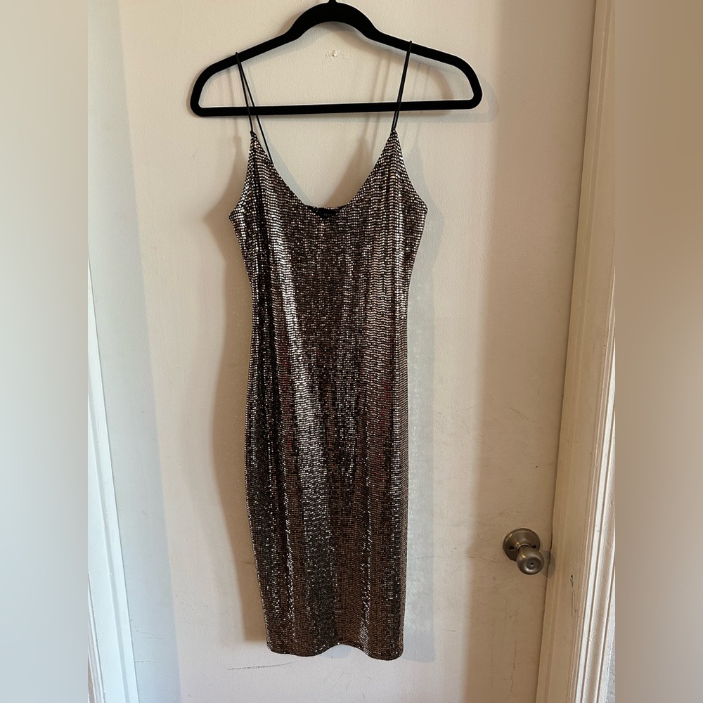 Seduction. Elegant dress in metal, spandex and nylon fabric.